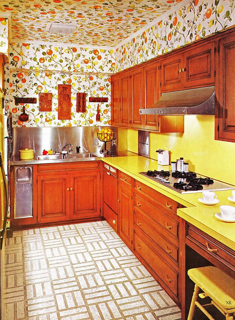 70s kitchen with dark wood cabinets and yellow counters